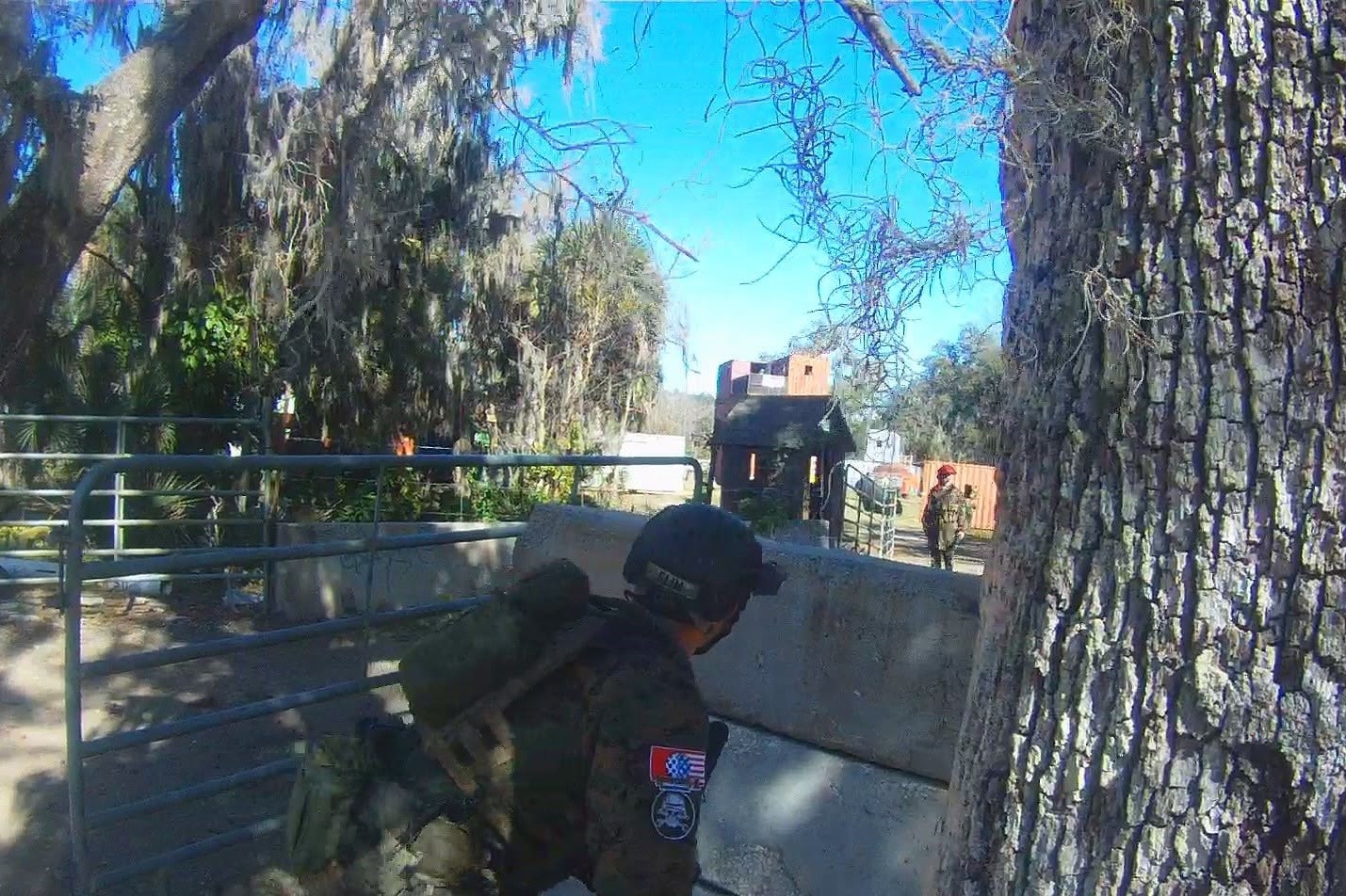 Player in German camo advancing behind a concrete barrier at the Amerika field