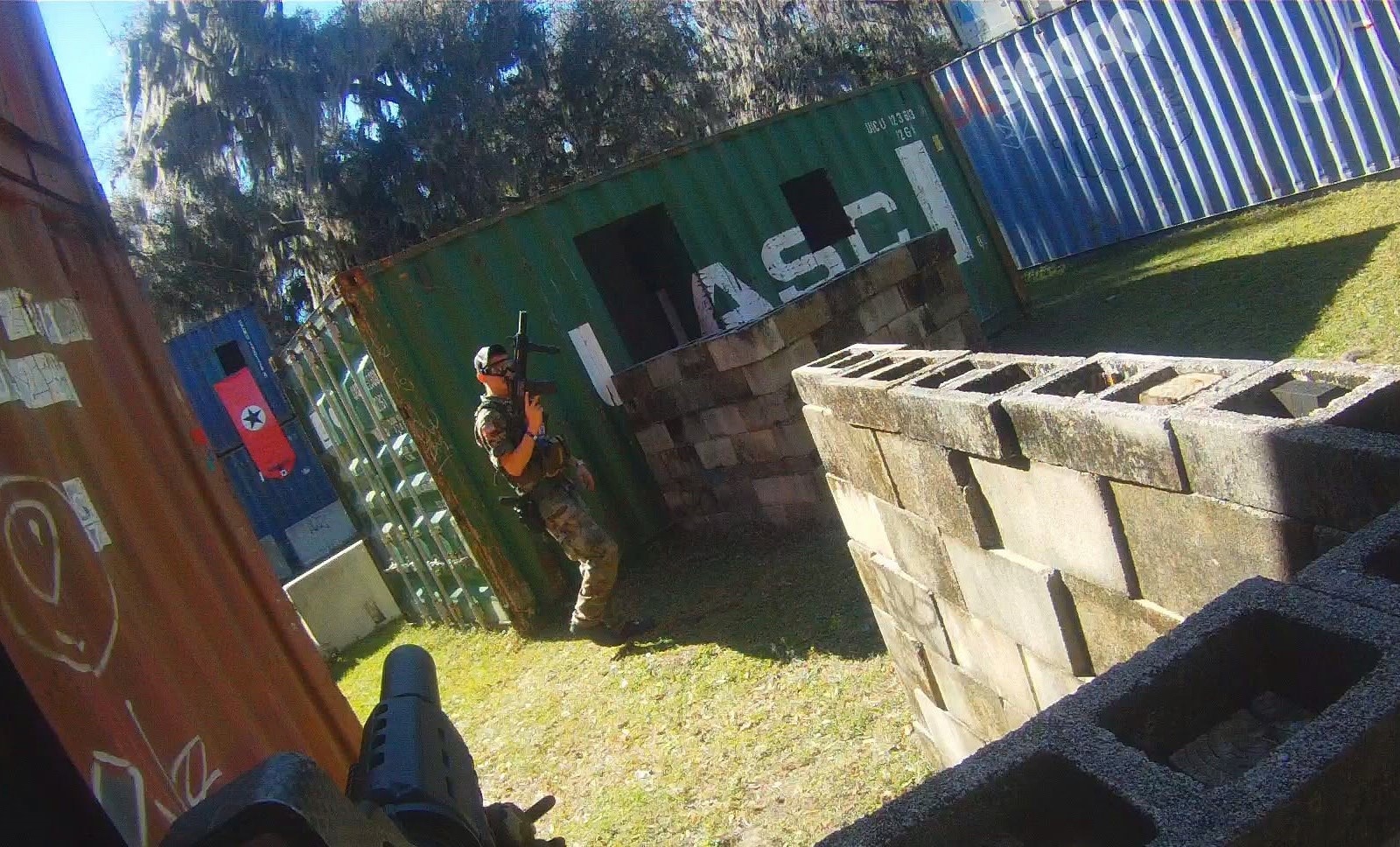 Player with rifle moving between shipping containers at Amerika