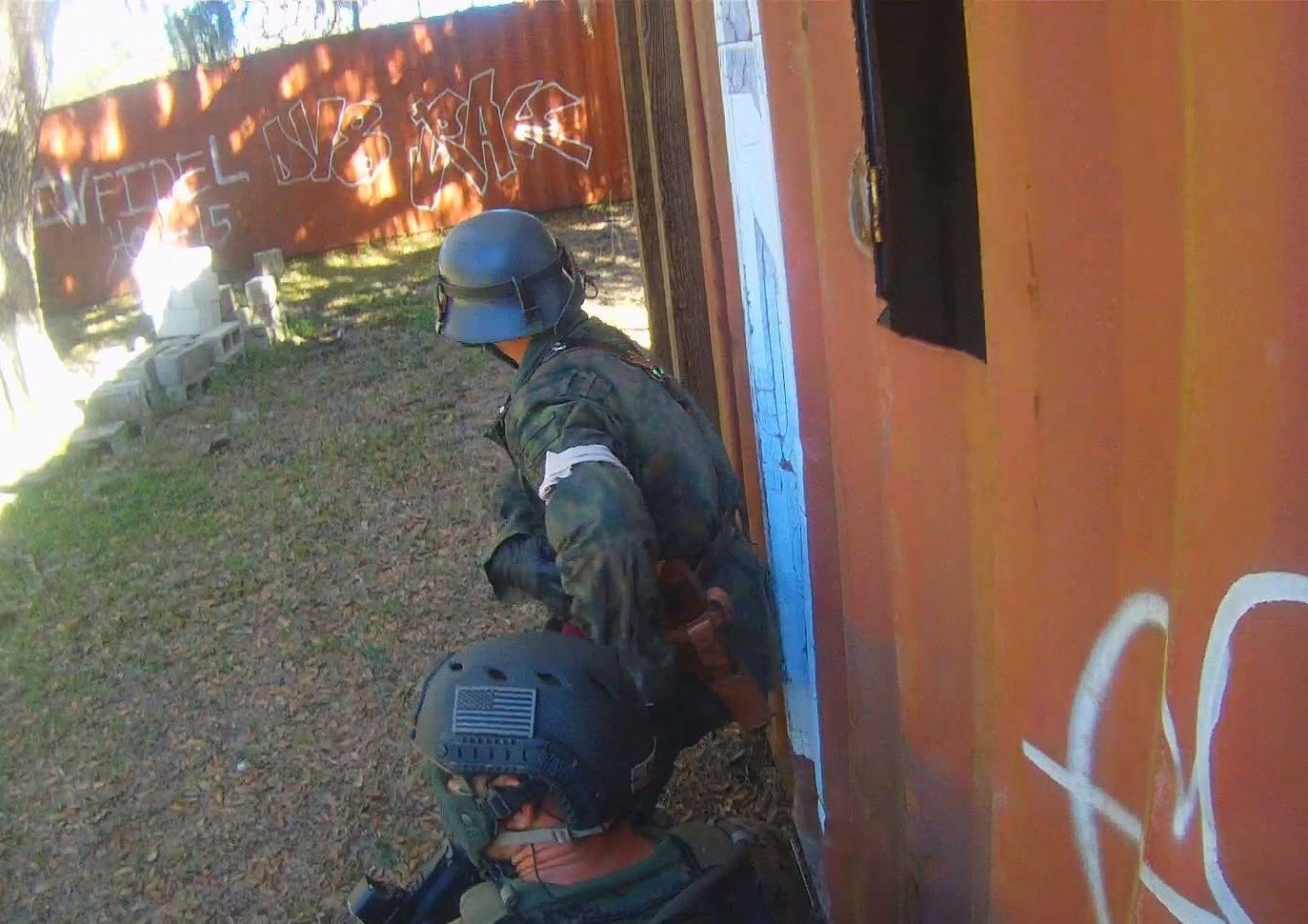 Two players in German helmets breaching a doorway at Amerika