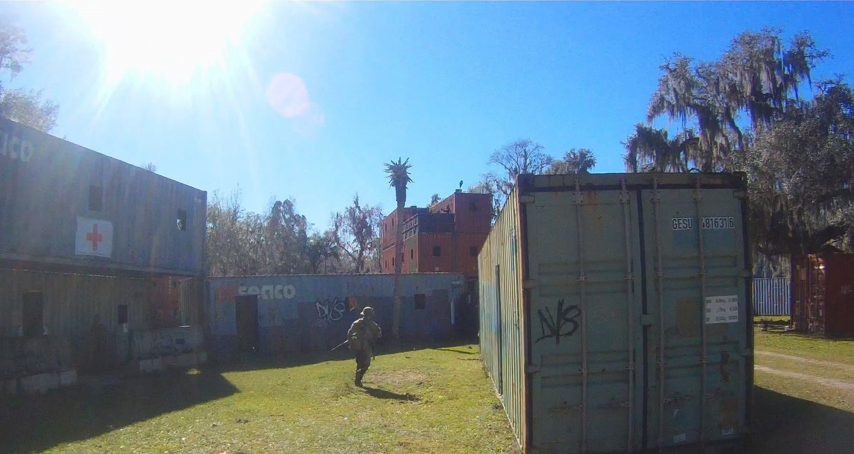 Player sprinting across the container field toward the medic station at Amerika