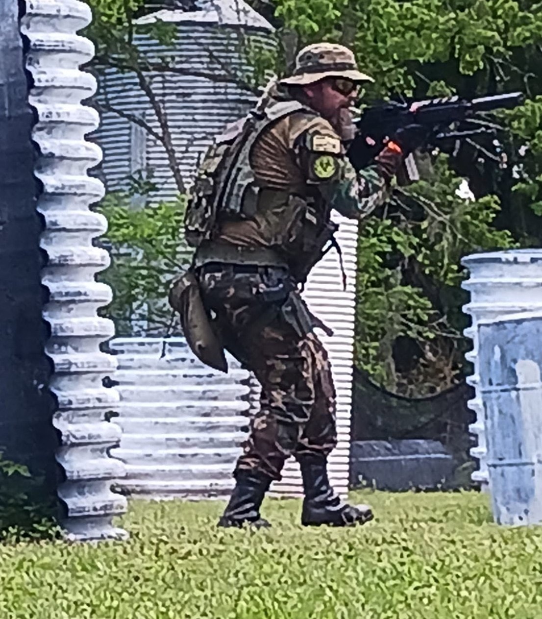 Camouflaged player advancing with rifle at King and Country
