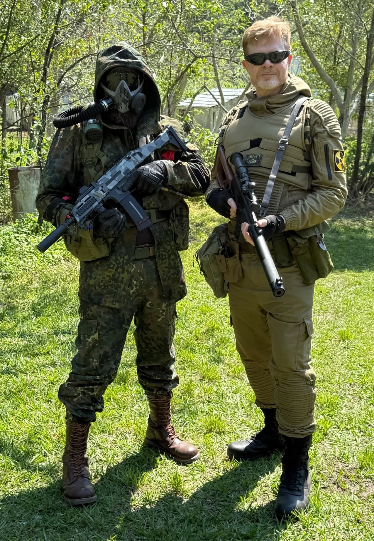 Two Zone players in tactical gear at the outdoor field