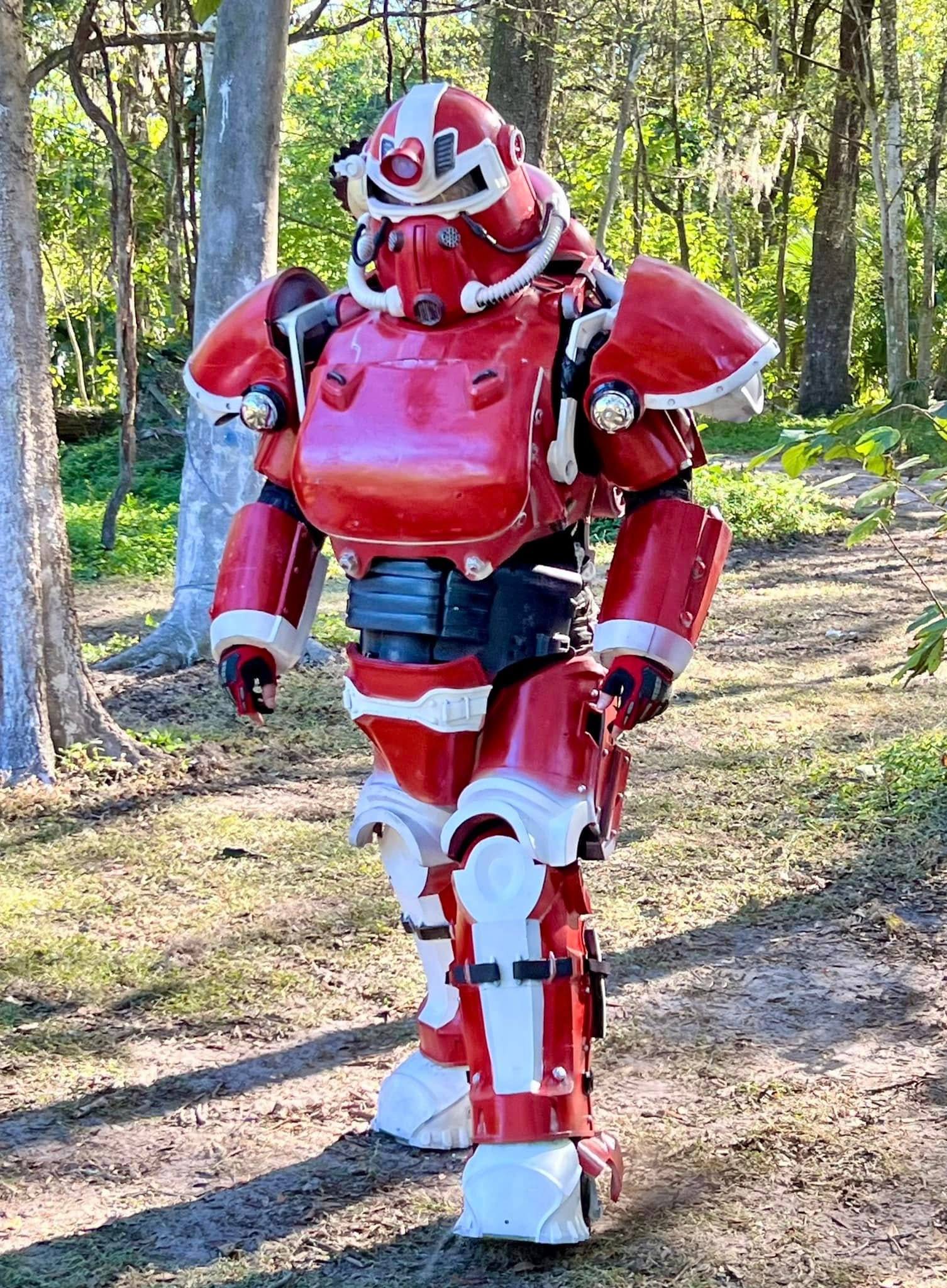 Red and white robot on forest trail
