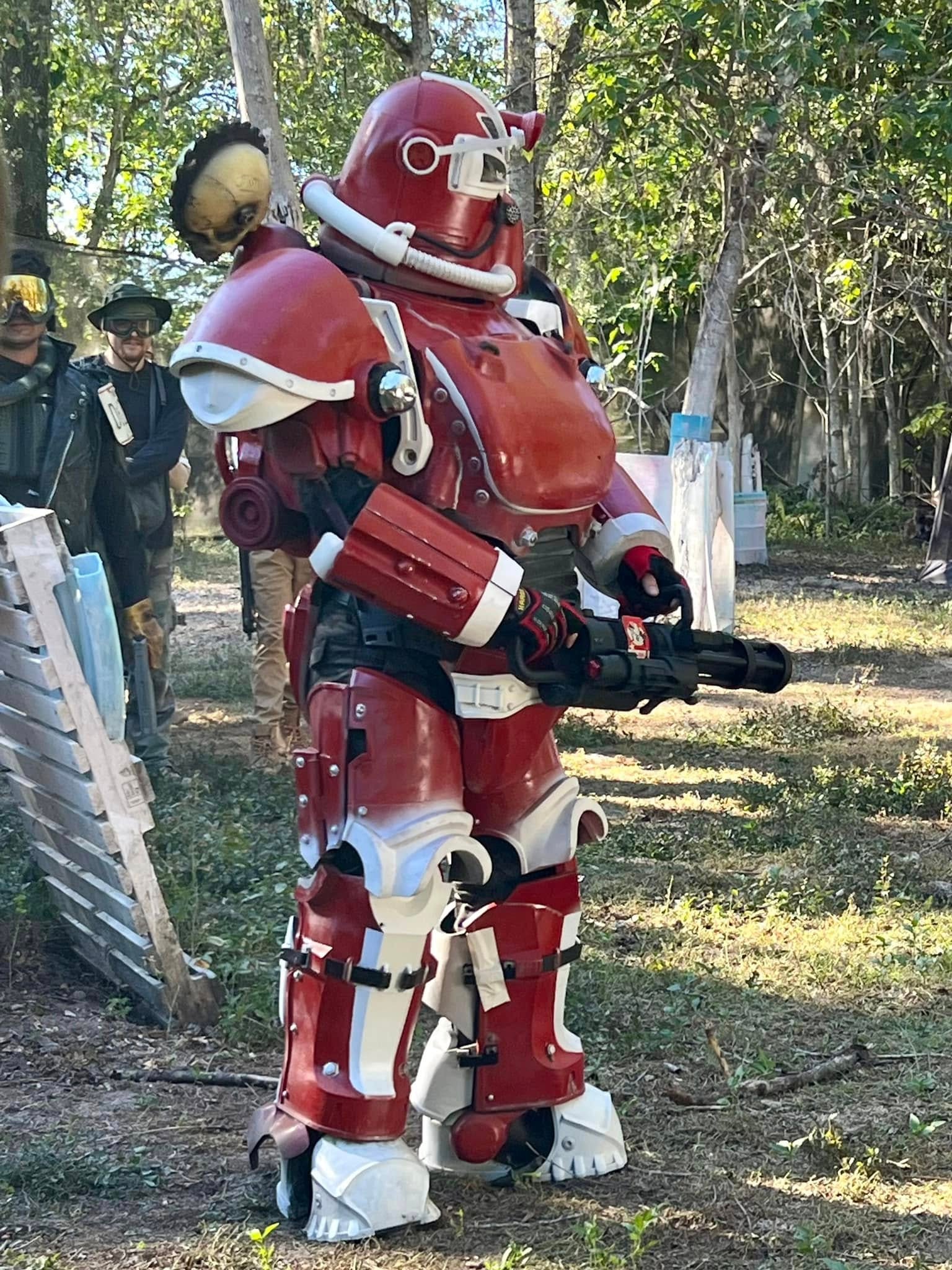 Red robot costume holding weapon outdoors
