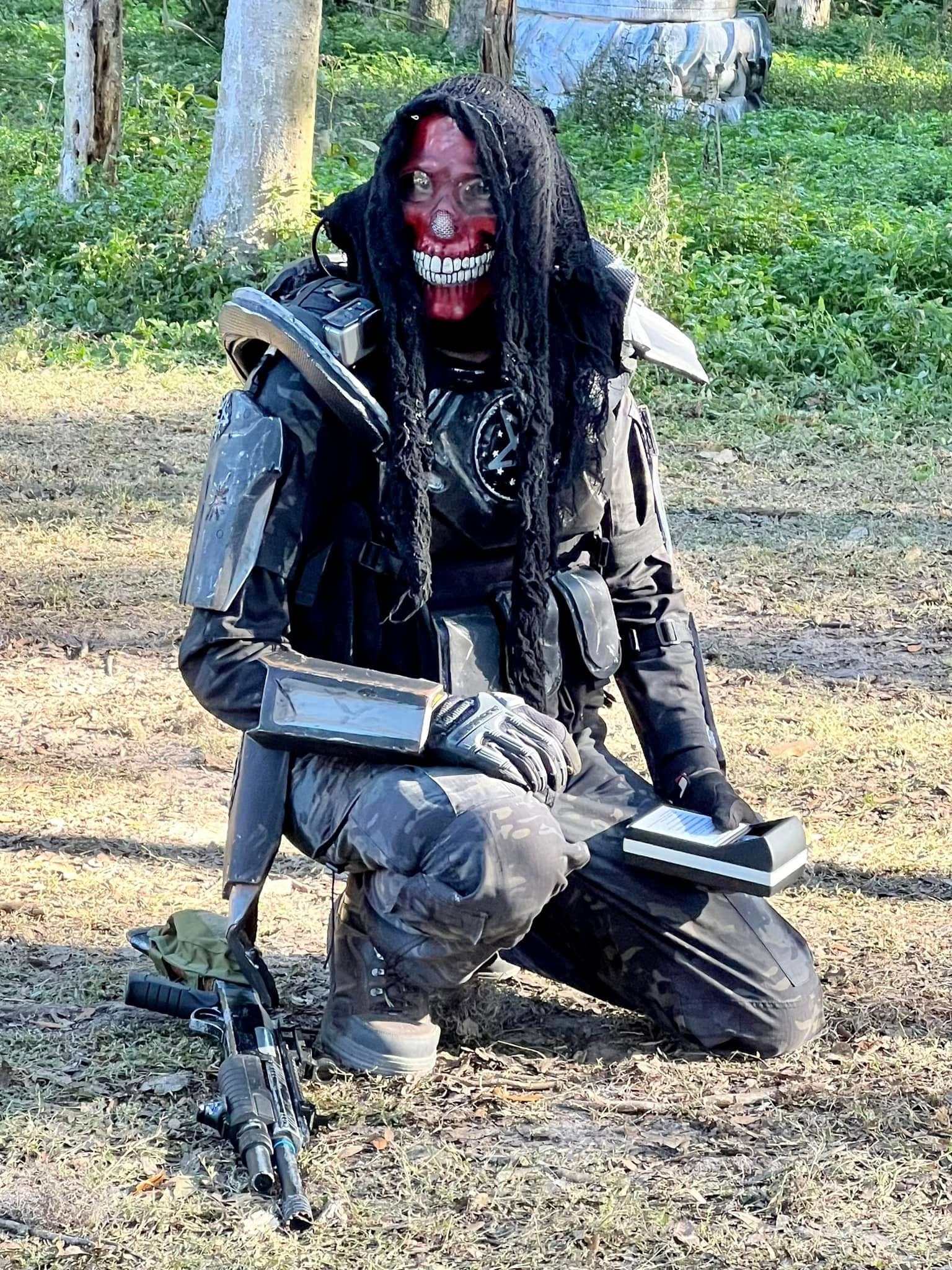 Player in skull makeup and tactical gear