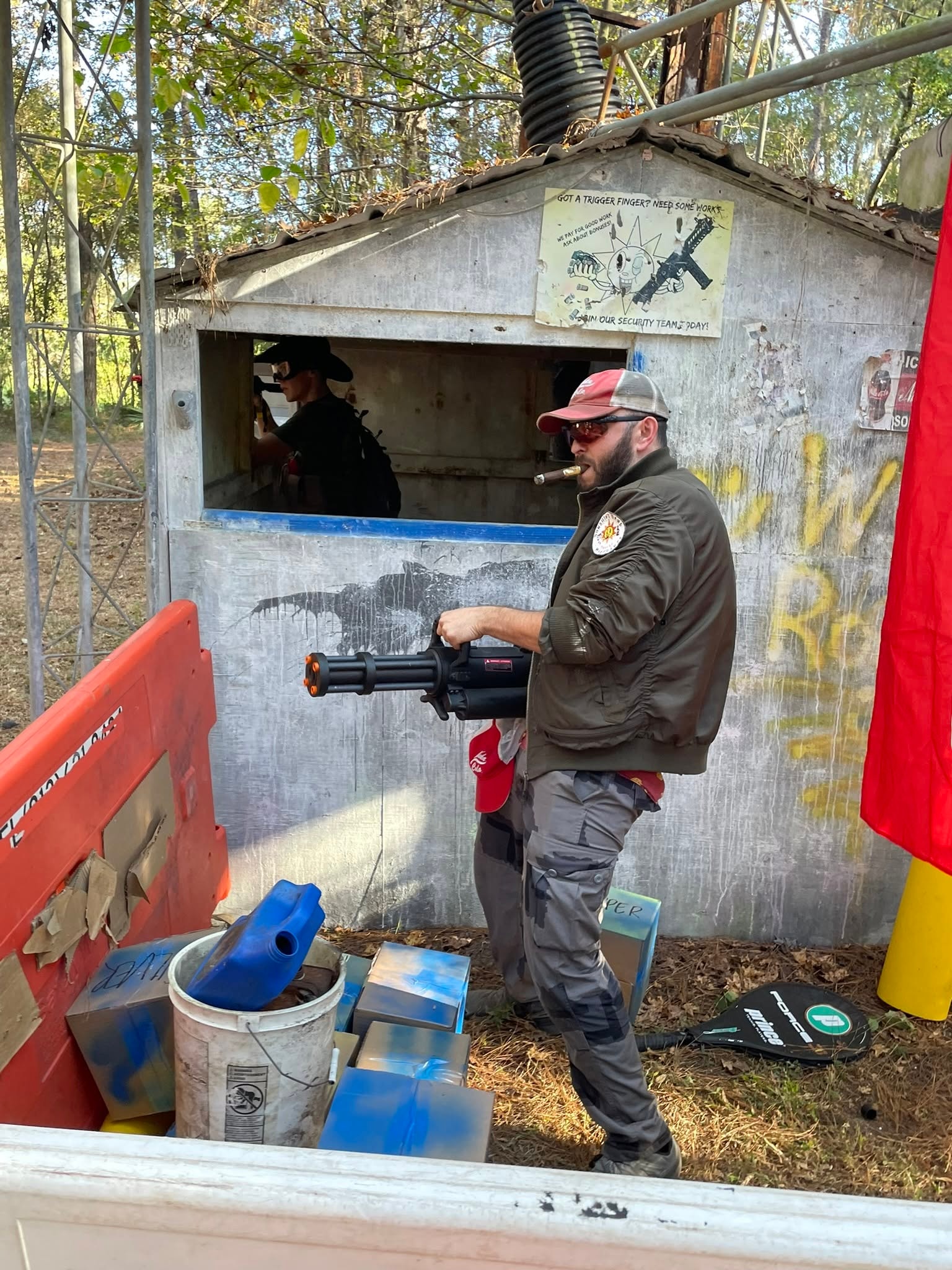 Man holding toy gun at shooting range booth
