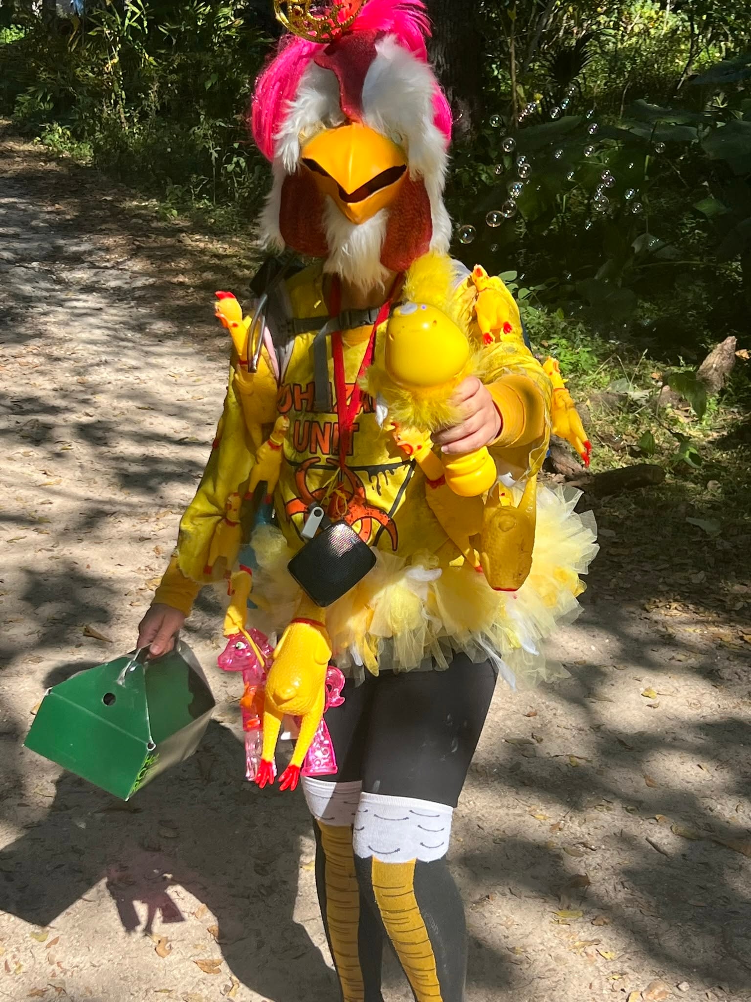 Person in colorful bird costume holding toys