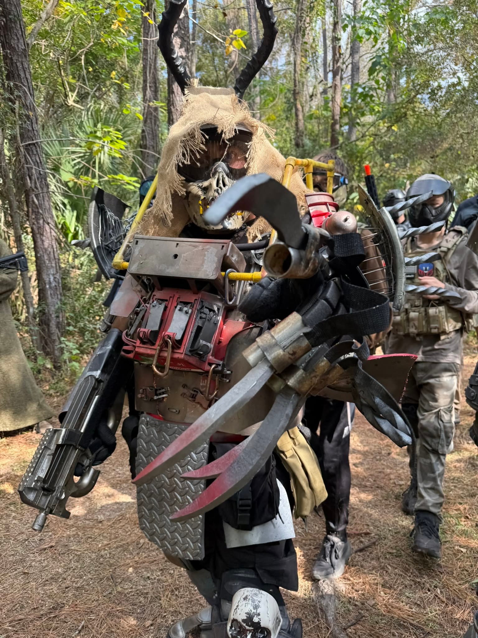 Costumed creature riding mechanical forest vehicle