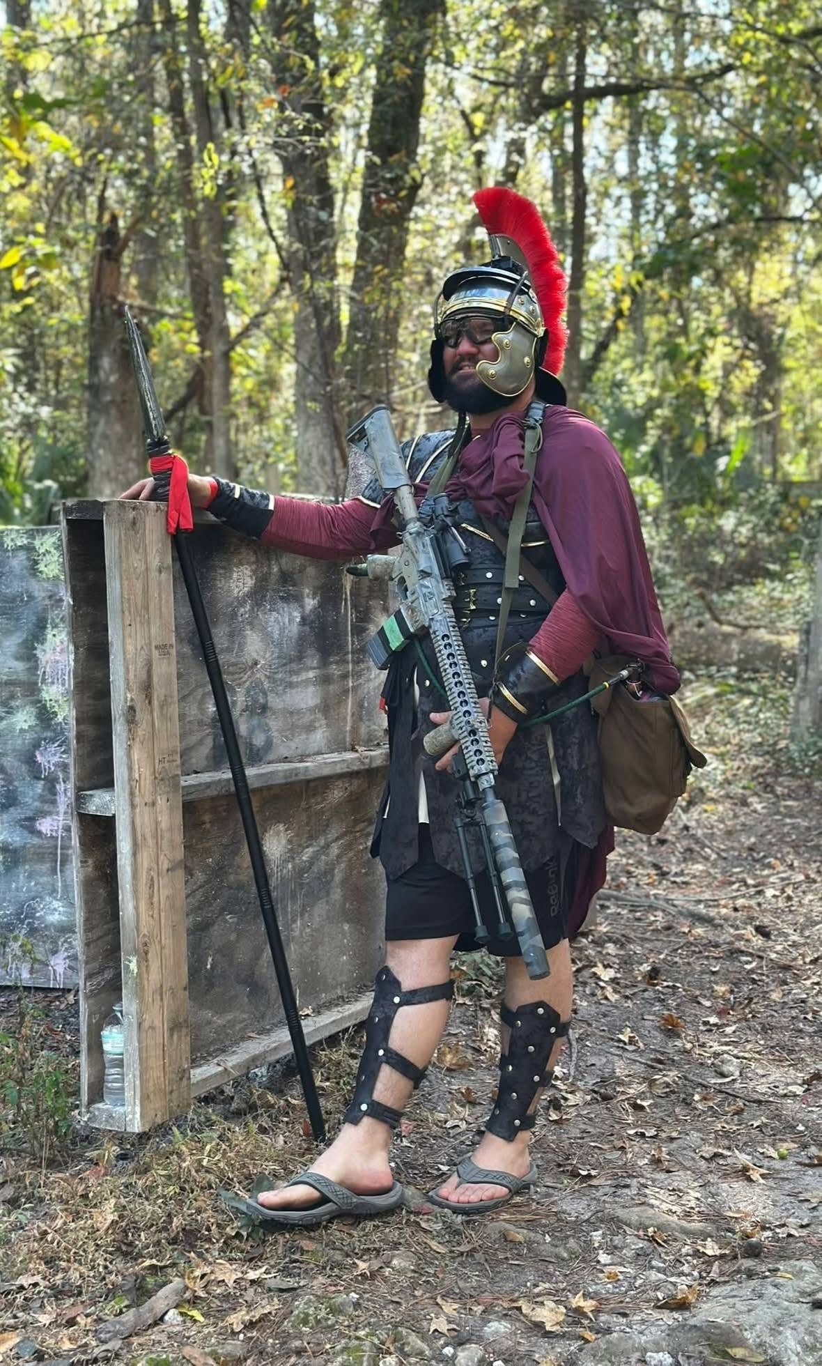 Roman centurion costumed player leaning on wooden structure