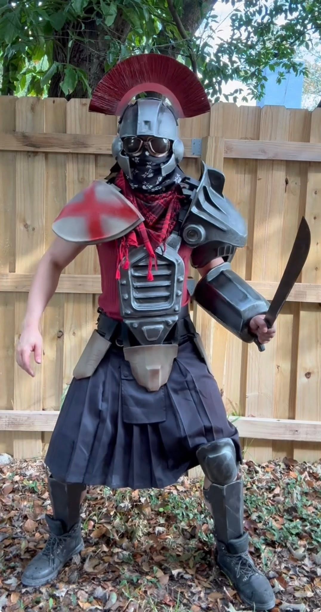Armored gladiator warrior with red crested helmet and machete