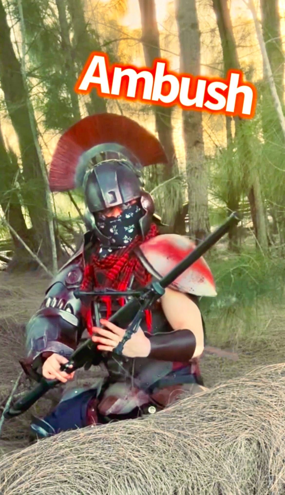 Armored warrior crouching behind hay bale in ambush