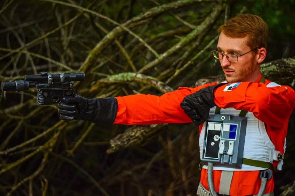 Man in orange suit aiming blaster